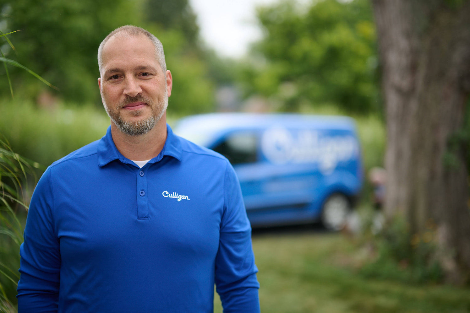 water filtration dealer standing in front of culligan van
