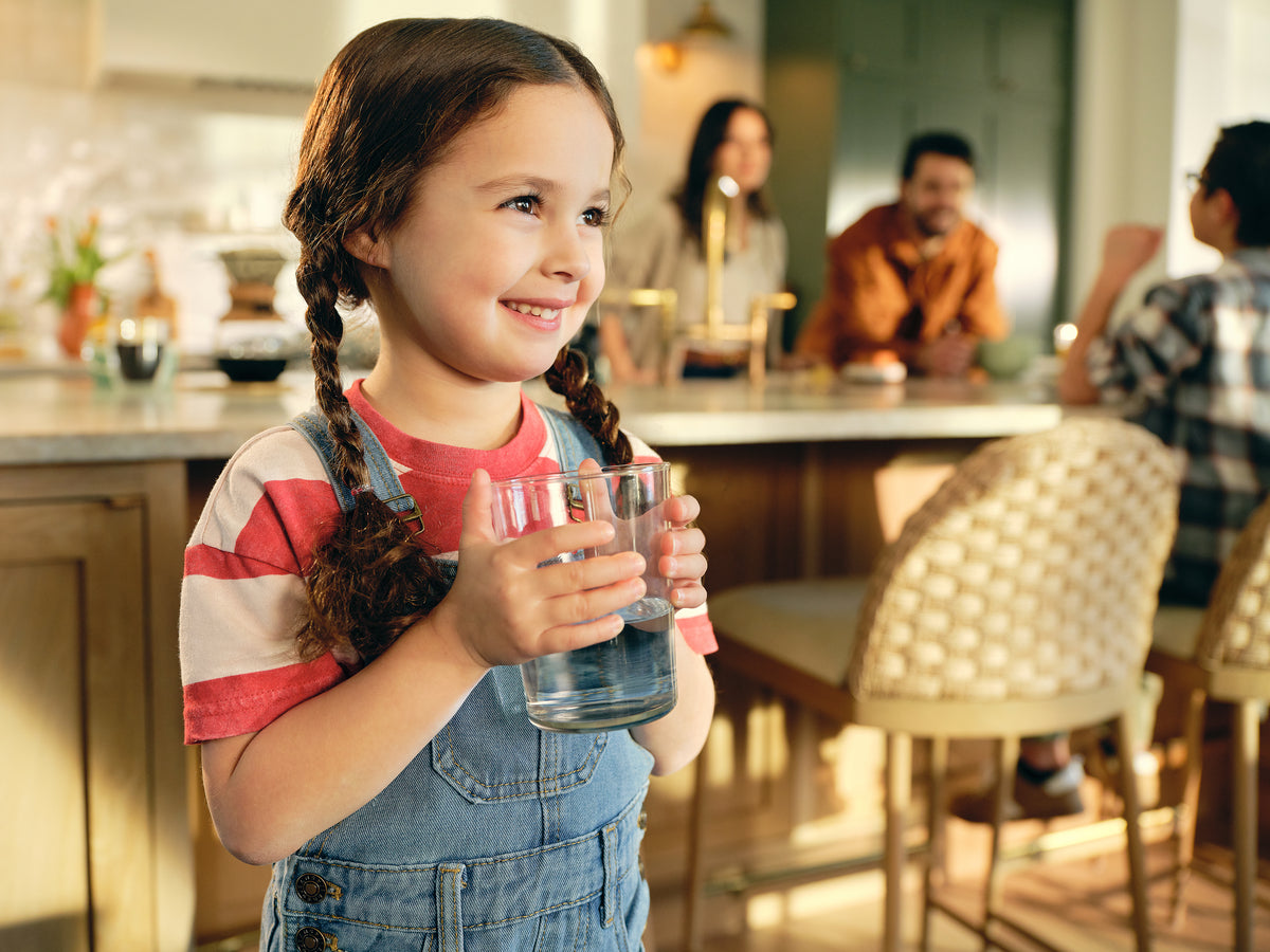 girl holding glass of water