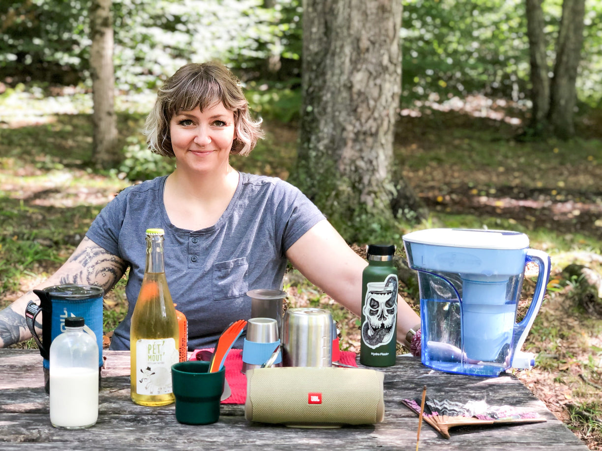Woman sitting with water bottles | ZeroWater Water Filter