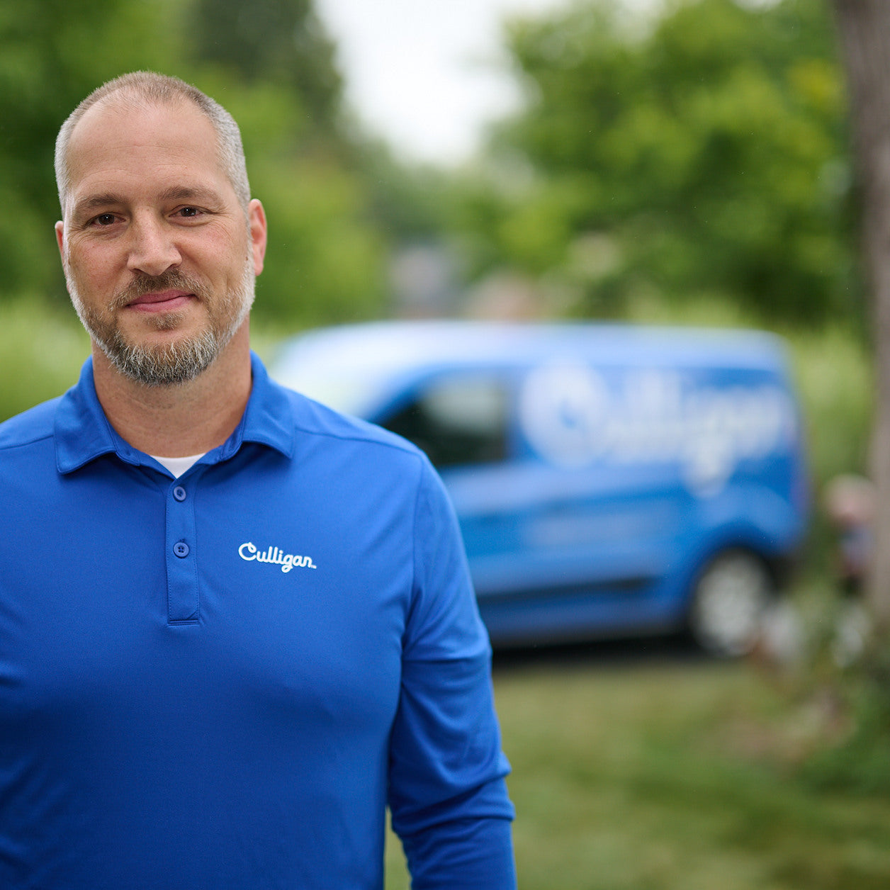 water filtration employee standing in front of culligan van