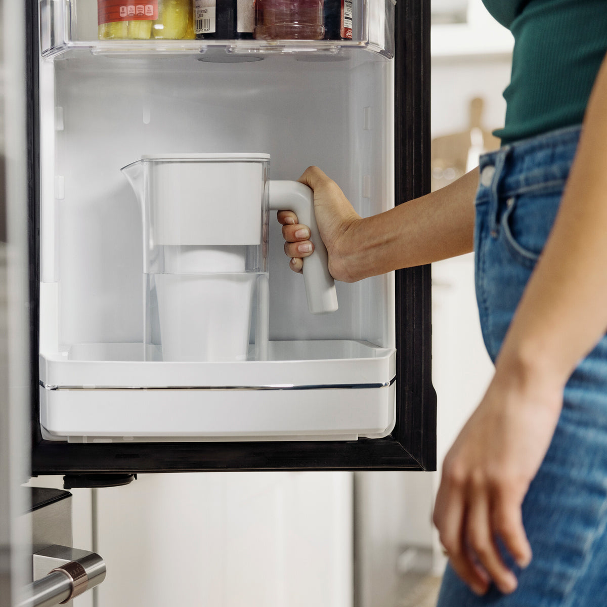 woman grabbing 7 cup zerowater pitcher from refrigerator door