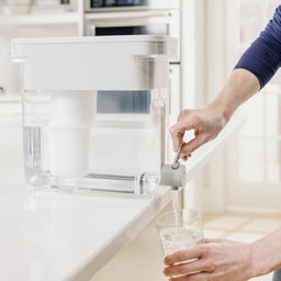 person pouring water from 22 cup zerowater dispenser spigot
