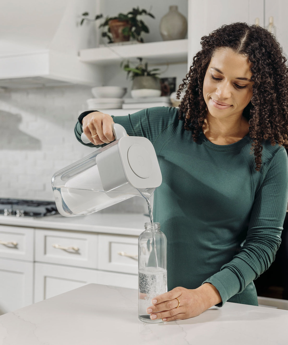 woman pouring water into bottle from 7 cup zerowater pitcher